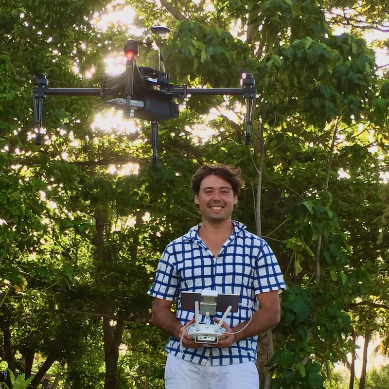 Sefa Percival holding a controller with a drone overhead